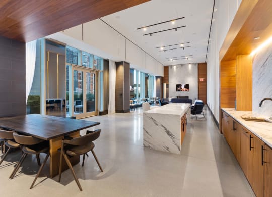 the kitchen and dining area of a large house with a marble table and chairs at The Paxton, Brooklyn, NY