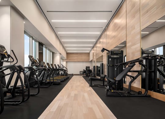 the gym is equipped with a variety of exercise equipment at The Paxton, Brooklyn, New York