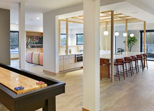 A room with a pool table and a framed picture on the wall.