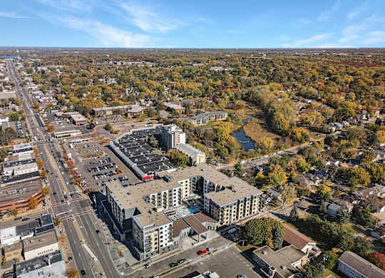 A large building with a parking lot in front of it.