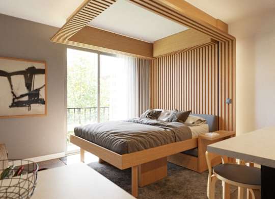 A bedroom with a bed, desk, and chair.