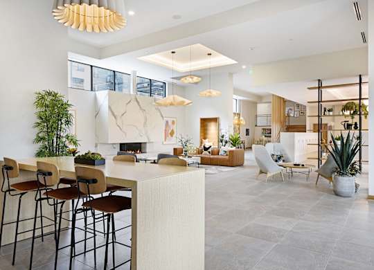 A modern living room with a bar area and a fireplace.