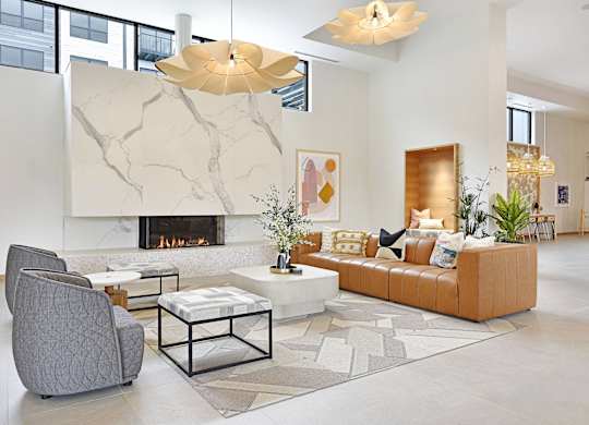 A modern living room with a fireplace and a grey armchair.