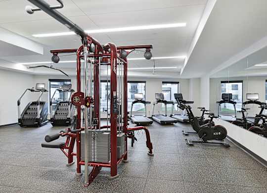 A gym with a variety of equipment including a leg press machine.
