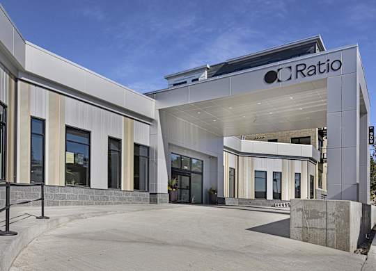 The image shows a modern building with the name