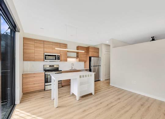 A modern kitchen with wooden accents and white appliances.