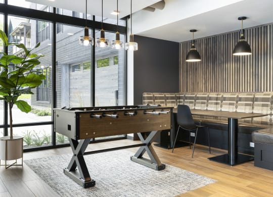 a pool table in a living room with a bar