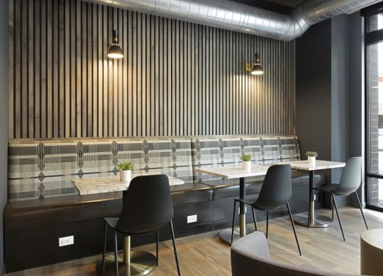 a restaurant with wooden tables and chairs and a large window