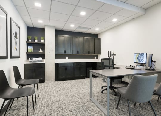 an office space with a desk and chairs and a computer