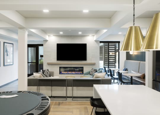 a kitchen and living room with a fireplace and a tv