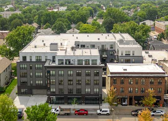 A large building with a parking lot in front of it.