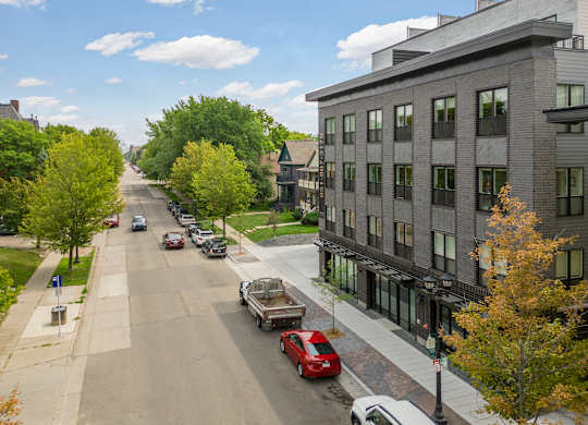 A street with cars and buildings on both sides.