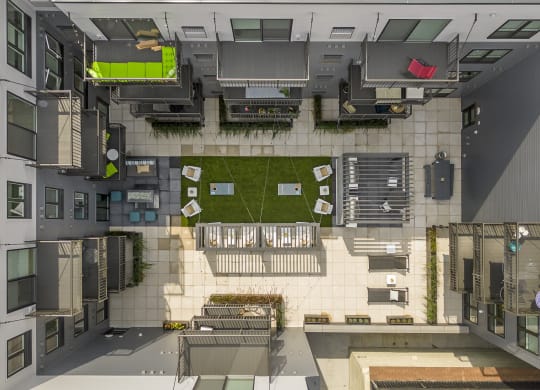 an overhead view of a building with a courtyard and a lawn