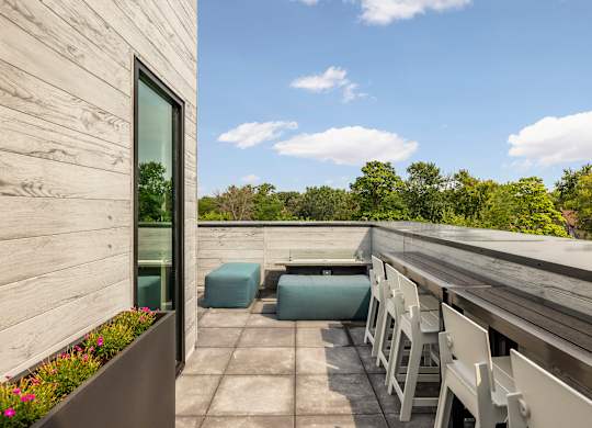 A wooden deck with chairs and a table.