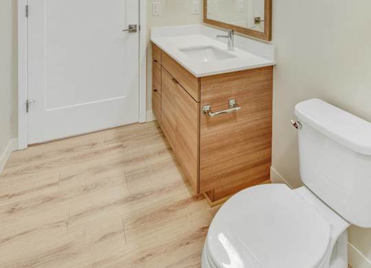 A white toilet sits next to a sink in a bathroom.