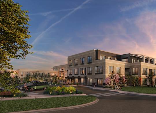 A modern building with a parking lot in front.