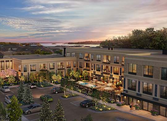 A modern apartment complex with a parking lot in front.