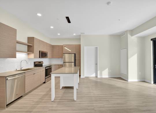 A modern kitchen with a dining table and chairs.