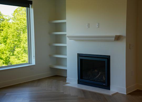 A fireplace in a room with a window.