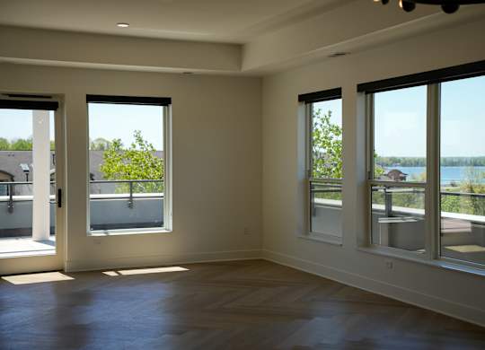 A room with a view of the lake through the windows.