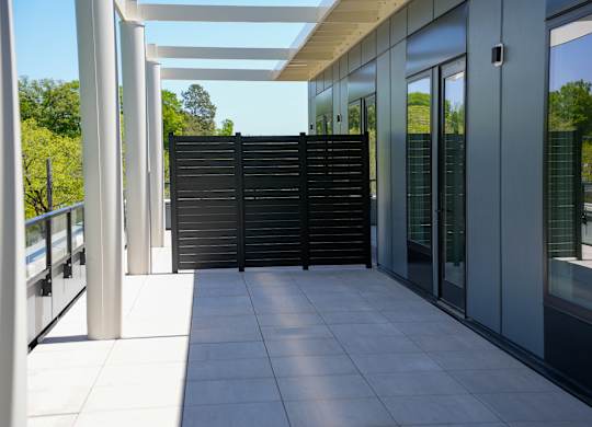 A modern building with a white tiled floor and a glass wall.