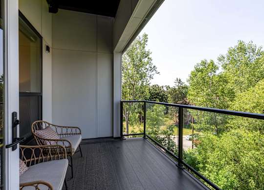 A balcony with a chair and a table.