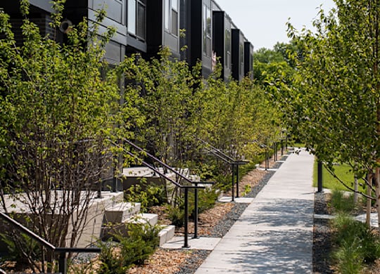 A modern building with a long walkway in front of it.