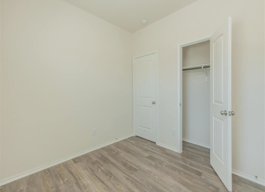 a bedroom with white walls and a wooden floor at The Village at Granger Pines, Conroe, 77302