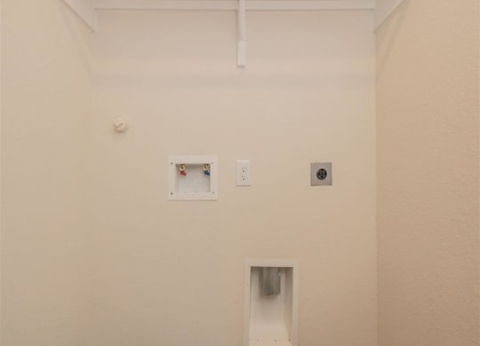 a white wall with two outlets and a light at The Village at Granger Pines, Conroe, TX