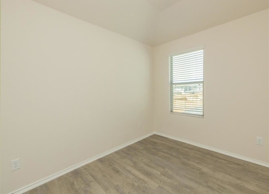 a bedroom with white walls and a window at The Village at Granger Pines, Conroe Texas