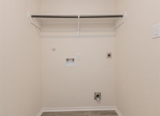 a room with a white wall and a white shelf at The Village at Granger Pines, Conroe, 77302
