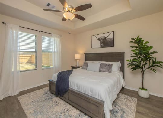 a bedroom with a bed and a ceiling fan  at The Village at Granger Pines, Conroe, TX 77302