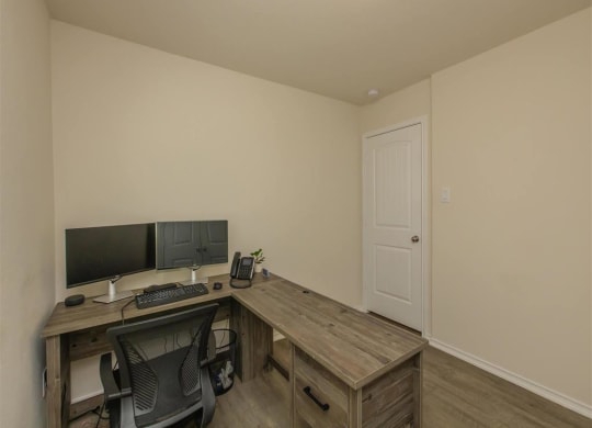 a home office with a desk and a computer at The Village at Granger Pines, Conroe, TX