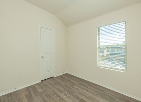 a bedroom with a window and a door  at The Village at Granger Pines, Conroe, TX 77302