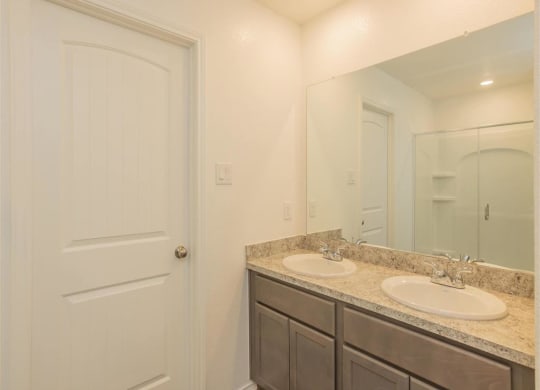 a bathroom with a sink and a mirror at The Village at Granger Pines, Conroe, 77302