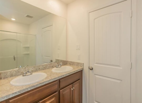 a bathroom with a sink and a mirror at The Village at Granger Pines, Conroe Texas