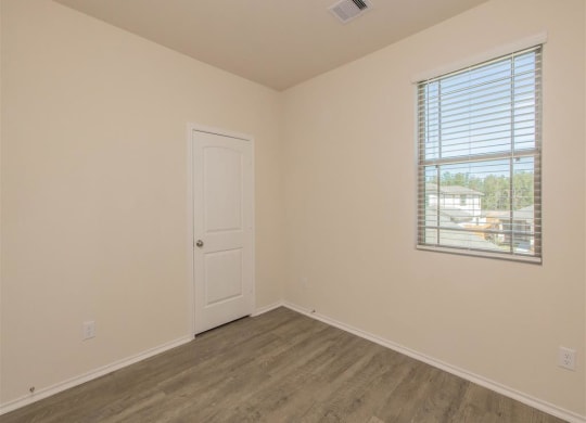 a bedroom with a window and a door at The Village at Granger Pines, Conroe, TX 77302