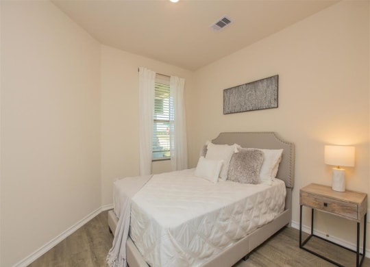 a bedroom with a bed and a window at The Village at Granger Pines, Conroe Texas