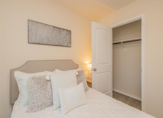 a bedroom with a bed and a closet at The Village at Granger Pines, Conroe, TX at The Village at Granger Pines, Conroe, 77302