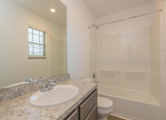 a bathroom with a sink toilet and shower at The Village at Granger Pines, Texas