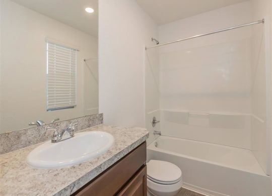 a bathroom with a sink toilet and shower at The Village at Granger Pines, Conroe, 77302