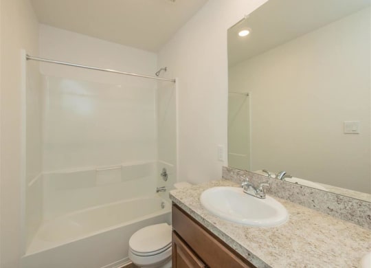 a bathroom with a sink toilet and shower at The Village at Granger Pines, Conroe, 77302