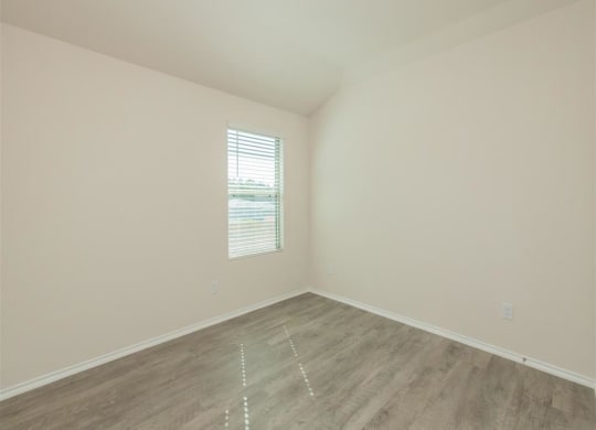 an empty room with white walls and a window at The Village at Granger Pines, Conroe, TX 77302