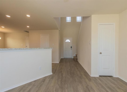 an empty room with a counter and a door  at The Village at Granger Pines, Conroe, TX 77302