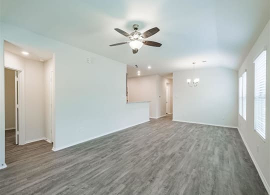 an empty living room with a ceiling fan at The Village at Granger Pines, Texas, 77302