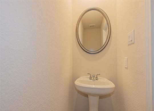 a bathroom with a sink and a mirror at The Village at Granger Pines, Texas, 77302