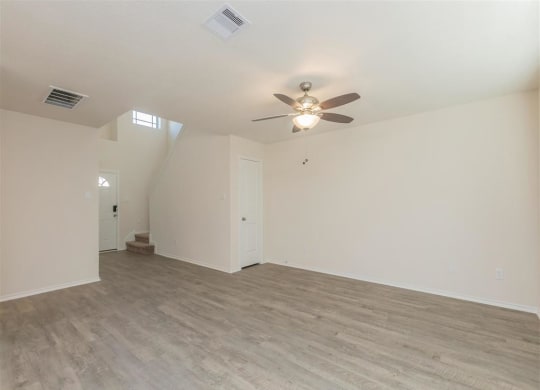 an empty living room with a ceiling fan at The Village at Granger Pines, Conroe, 77302