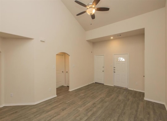 an empty living room with a ceiling fan at The Village at Granger Pines, Conroe Texas