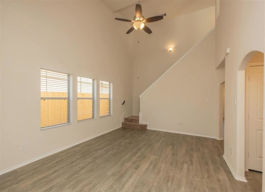 an empty living room with a ceiling fan at The Village at Granger Pines, Conroe, 77302