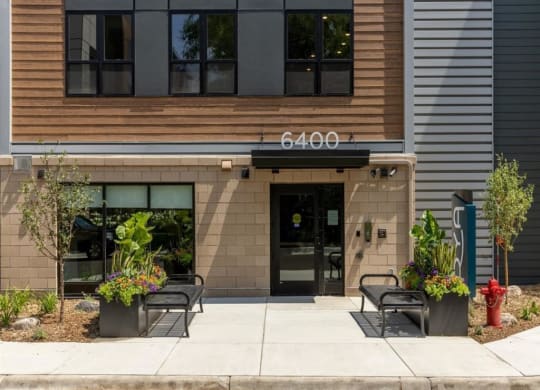 a building with two benches and a fire hydrant in front of it